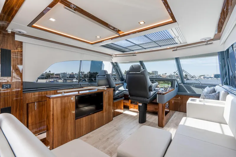 Slide: The Image of Luxurious interior of 2023 Riviera 64 Sports Motor Yacht with waterfront view. - 17
