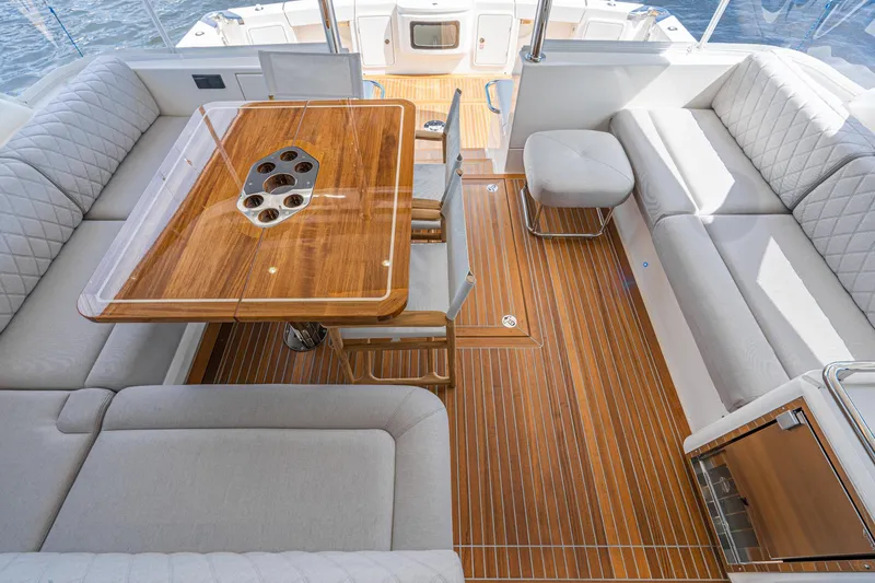 Slide: The Image of Luxurious interior of 2023 Riviera 64 Sports Motor Yacht with elegant seating and wooden table. - 27