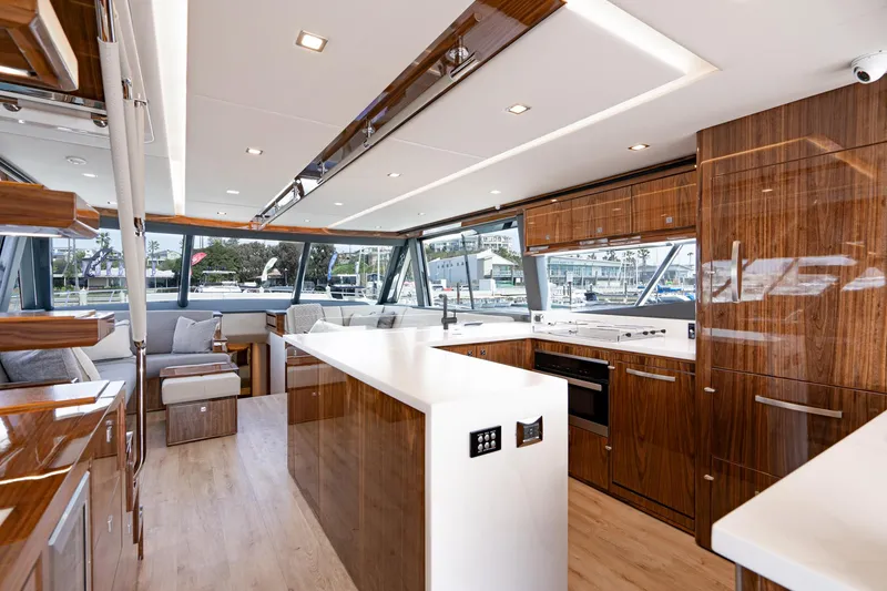 Slide: The Image of Luxurious interior of 2023 Riviera 64 Sports Motor Yacht with modern furnishings and panoramic windows. - 28