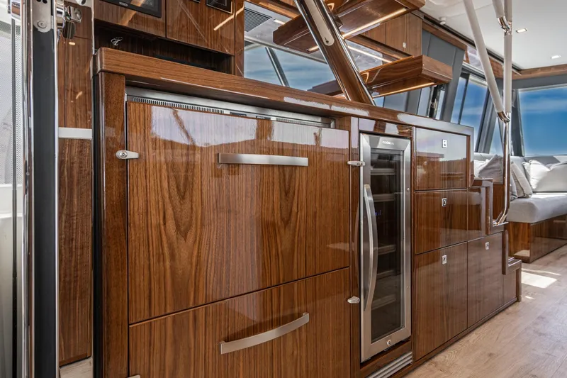 Slide: The Image of Luxurious interior of 2023 Riviera 64 Sports Motor Yacht with panoramic windows and elegant seating. - 29