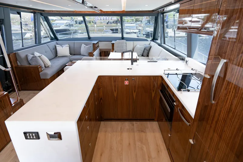 Slide: The Image of Luxurious interior of 2023 Riviera 64 Sports Motor Yacht with plush seating and modern helm. - 30