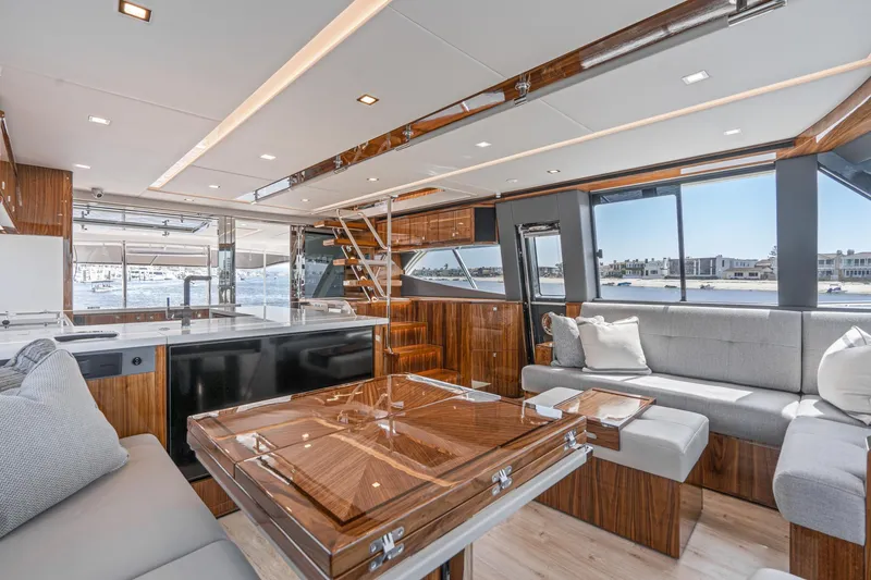 Slide: The Image of Luxurious 2023 Riviera 64 Sports Motor Yacht with elegant seating and scenic ocean view. - 37