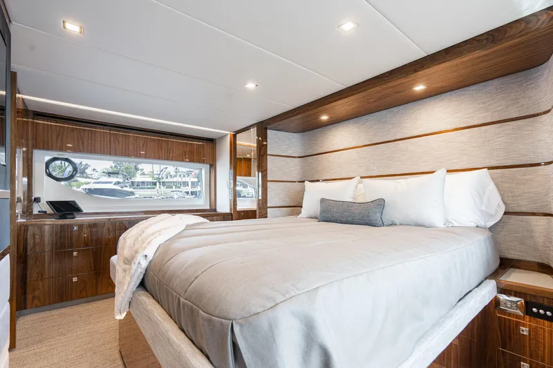 Slide: The Image of Luxurious bedroom interior of 2023 Riviera 64 Sports Motor Yacht with elegant wood finishes. - 40