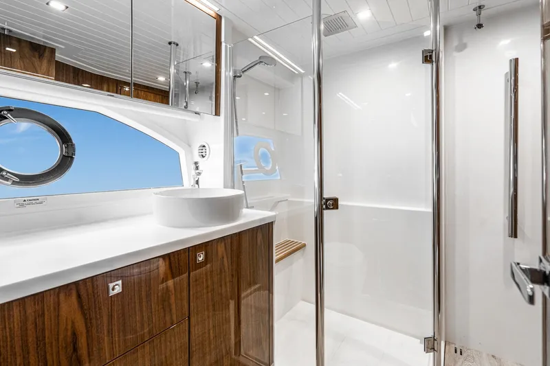 Slide: The Image of Luxurious bathroom in 2023 Riviera 64 Sports Motor Yacht with modern fixtures and elegant design. - 42