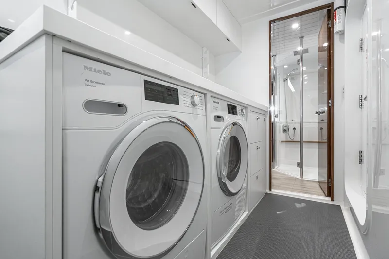 Slide: The Image of Interior of 2023 Riviera 64 Sports Motor Yacht with bunk beds and wooden cabinetry. - 45