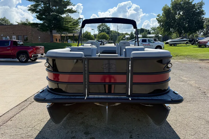 Slide: The Image of 2026 Bentley Pontoons Legacy 223 Swingback, black and red, parked outdoors on a sunny day. - 2