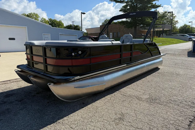 Slide: The Image of 2026 Bentley Pontoons Legacy 223 Swingback on pavement, showcasing sleek design and modern features. - 3