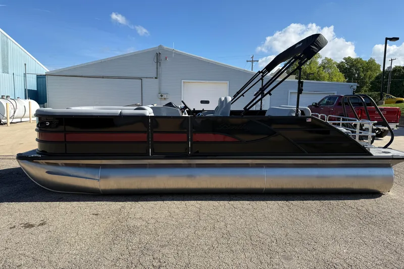 Slide: The Image of 2026 Bentley Pontoons Legacy 223 Swingback, black and red design, parked outdoors. - 4