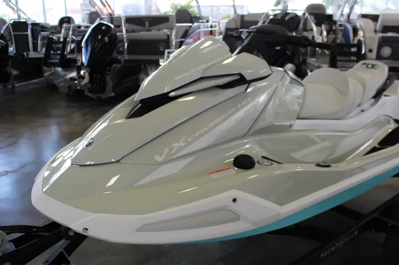 Slide: The Image of 2025 Yamaha VX Cruiser HO jet ski in showroom, sleek design and modern features. - 2