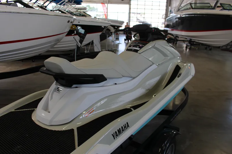 Slide: The Image of 2025 Yamaha VX Cruiser HO jet ski displayed in a showroom with boats in the background. - 5