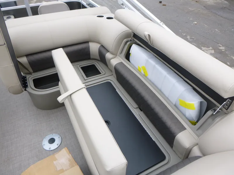 Slide: The Image of 2025 Sun Tracker Fishin' Barge 20 DLX interior seating with storage compartments. - 11