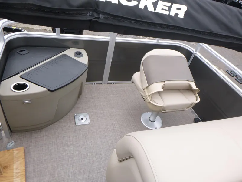 Slide: The Image of 2025 Sun Tracker Fishin' Barge 20 DLX interior with seating and storage. - 12