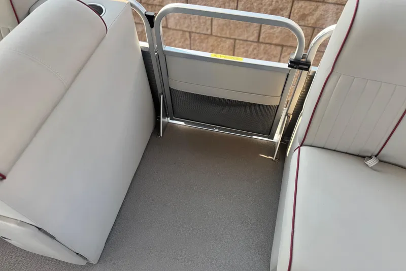 Slide: The Image of Interior of 2016 Apex Qwest 7518 LS boat with white seating and safety gate. - 13