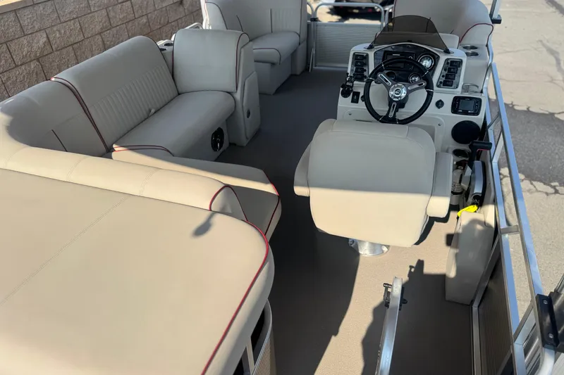 Slide: The Image of Luxurious interior of 2016 Apex Qwest 7518 LS pontoon boat with plush seating and helm. - 21