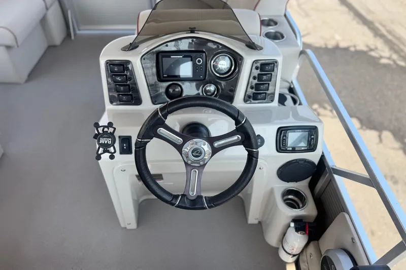 Slide: The Image of Steering console of 2016 Apex Qwest 7518 LS boat with modern controls and navigation system. - 23