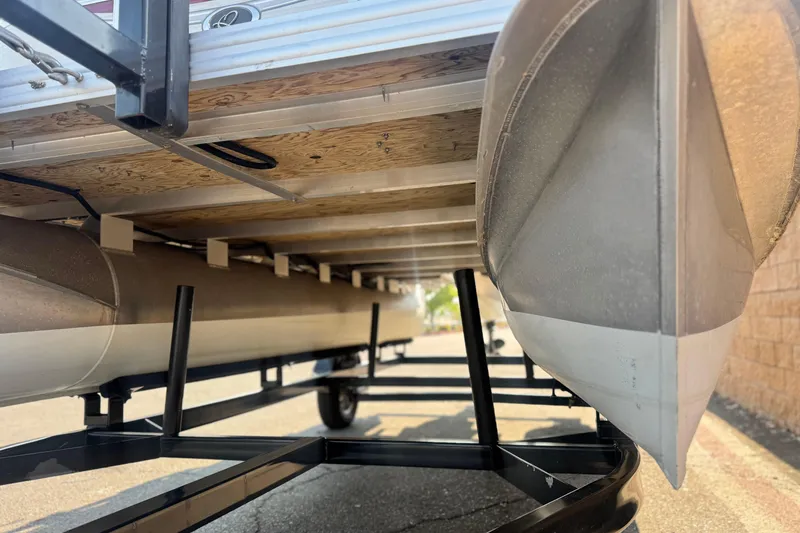 Slide: The Image of Underneath view of a 2016 Apex Qwest 7518 LS pontoon boat on a trailer. - 4