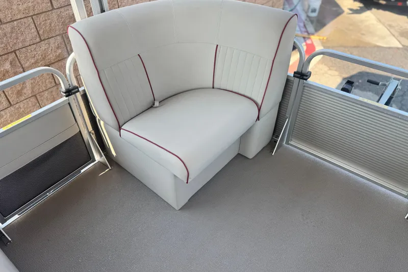 Slide: The Image of 2016 Apex Qwest 7518 LS boat interior with white cushioned seating and red accents. - 10