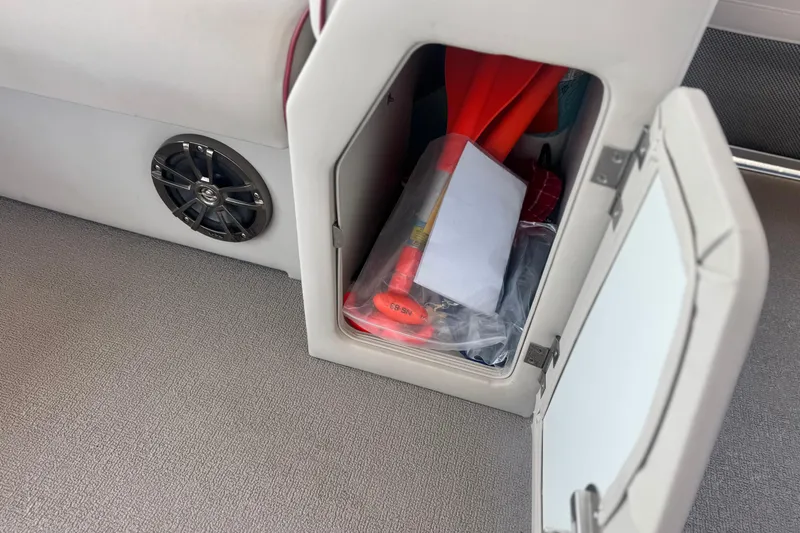 Slide: The Image of Storage compartment in 2016 Apex Qwest 7518 LS boat with safety equipment. - 15