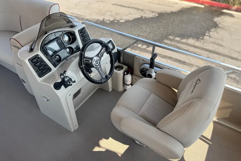 Slide: The Image of Captain's helm of 2016 Apex Qwest 7518 LS boat with steering wheel and controls. - 22