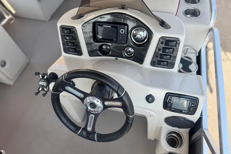 Slide: The Image of Steering console of 2016 Apex Qwest 7518 LS boat with modern controls and gauges. - 24