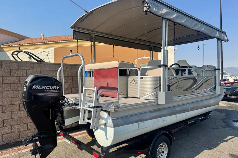 Slide: The Image of 2016 Apex Qwest 7518 LS pontoon boat with Mercury engine on trailer. - 6