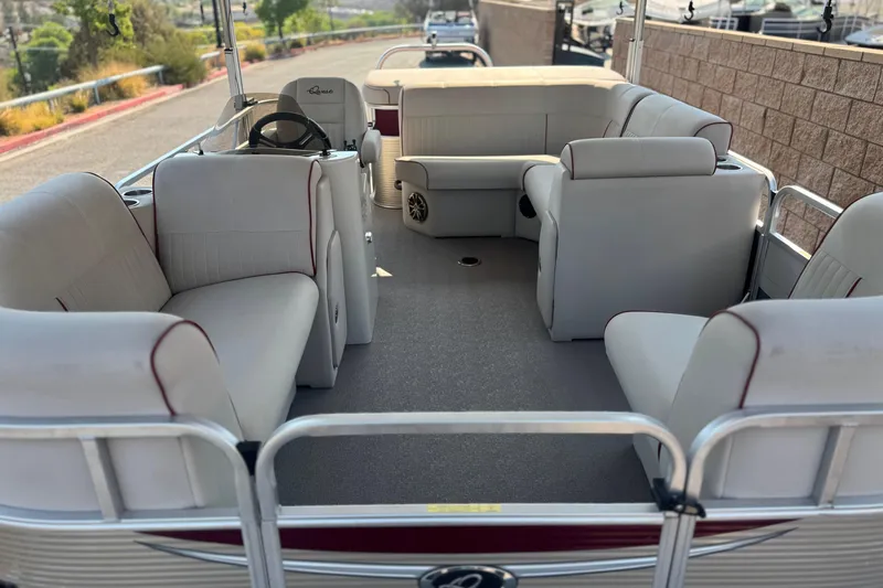 Slide: The Image of 2016 Apex Qwest 7518 LS pontoon boat interior with spacious seating and steering console. - 8
