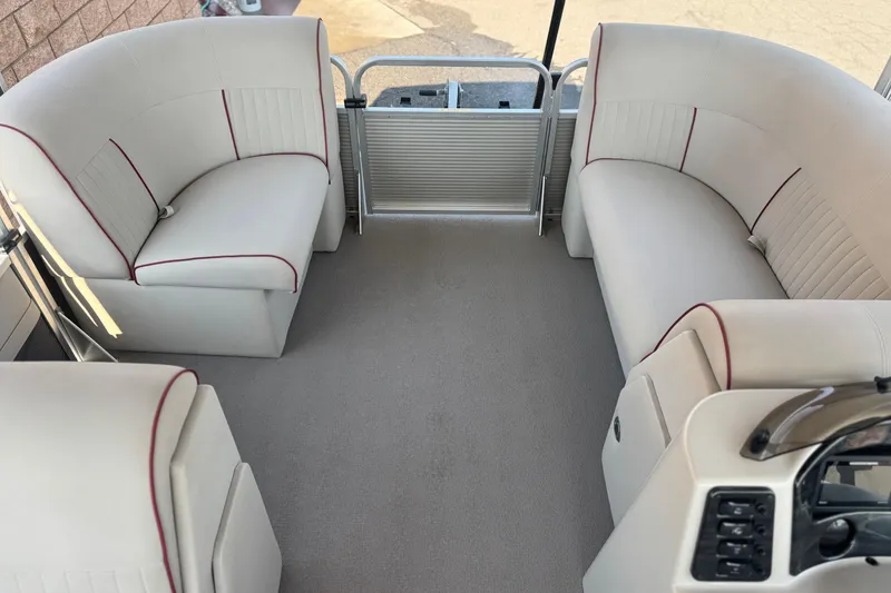 Slide: The Image of 2016 Apex Qwest 7518 LS boat interior with beige seating and red accents. - 9
