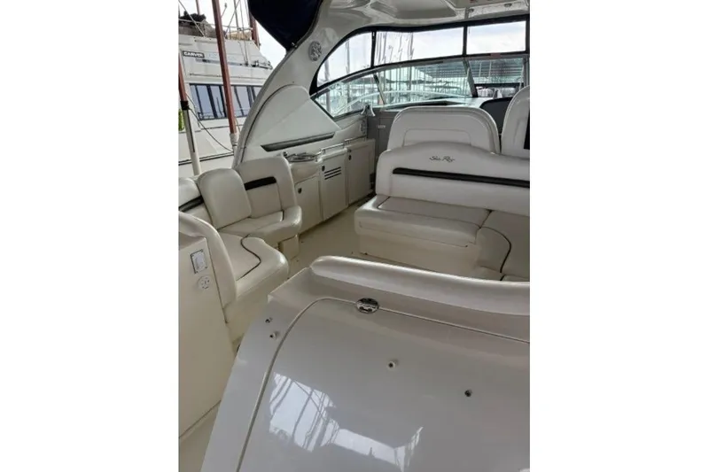 Slide: The Image of 2006 Sea Ray 38 Sundancer yacht interior with white seating and sleek design. - 11