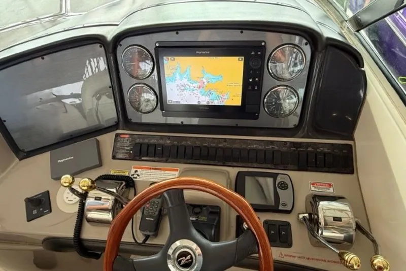 Slide: The Image of Helm of 2006 Sea Ray 38 Sundancer with navigation display and controls. - 12