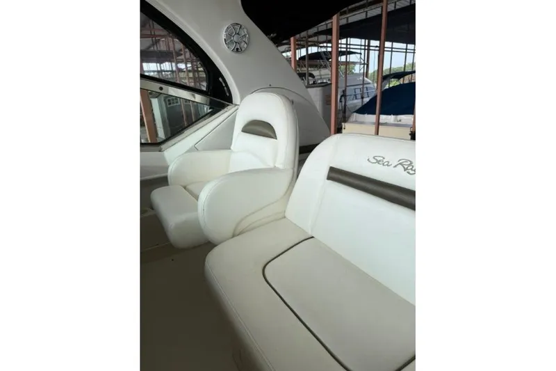 Slide: The Image of 2006 Sea Ray 38 Sundancer cockpit with white leather seats and window view. - 14