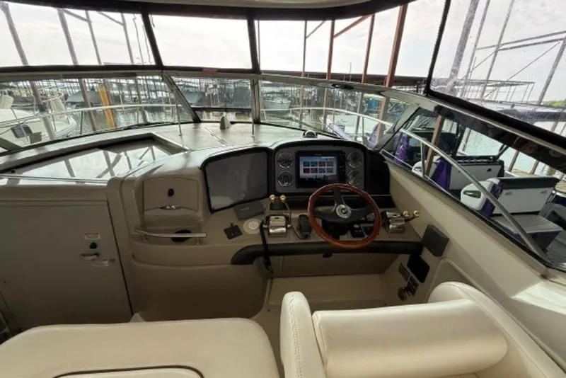 Slide: The Image of 2006 Sea Ray 38 Sundancer helm with modern controls and navigation system. - 16