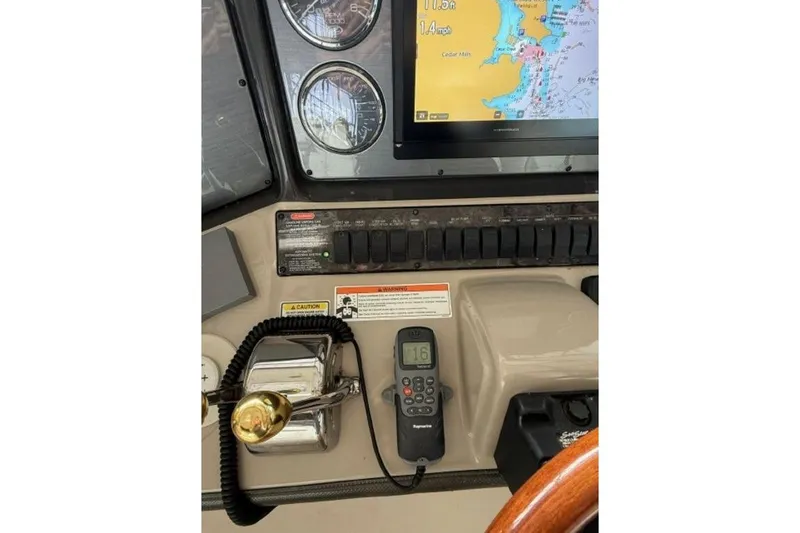 Slide: The Image of Control panel of 2006 Sea Ray 38 Sundancer with navigation screen and gauges. - 19