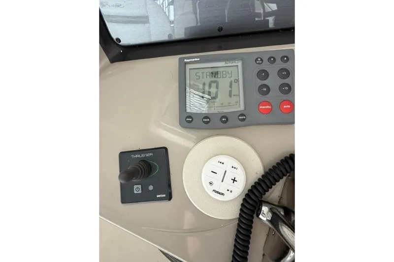 Slide: The Image of Control panel of a 2006 Sea Ray 38 Sundancer boat with autopilot and thruster controls. - 20