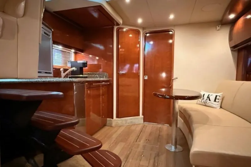 Slide: The Image of Interior of 2006 Sea Ray 38 Sundancer yacht with elegant wood finishes and cozy seating. - 26