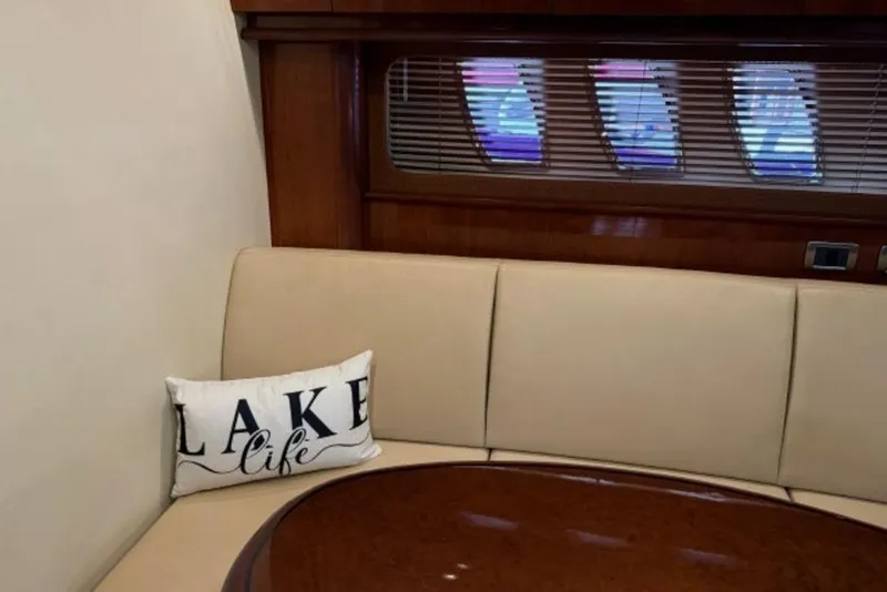 Slide: The Image of Interior of 2006 Sea Ray 38 Sundancer with beige seating and "Lake Life" pillow. - 27