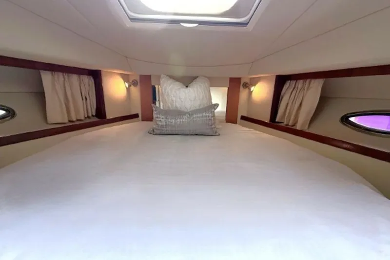 Slide: The Image of Interior cabin of 2006 Sea Ray 38 Sundancer with cozy bedding and ambient lighting. - 37