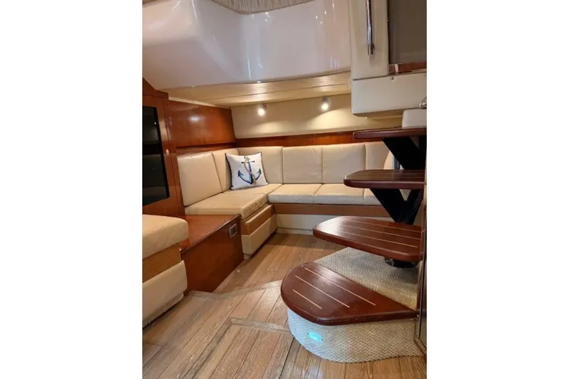 Slide: The Image of Luxurious interior of 2006 Sea Ray 38 Sundancer yacht with elegant seating and wooden stairs. - 39