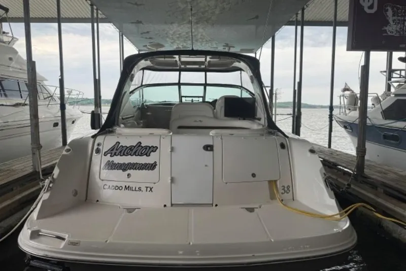 Slide: The Image of 2006 Sea Ray 38 Sundancer docked, rear view, with "Anchor Management" signage. - 4
