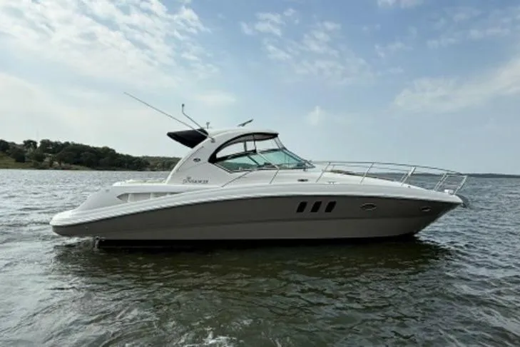 Slide: The Image of 2006 Sea Ray 38 Sundancer yacht on calm water under a partly cloudy sky. - 45