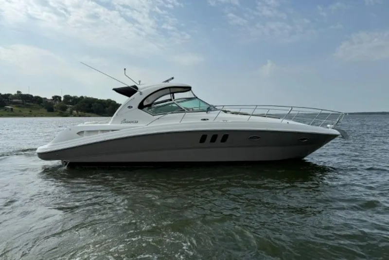 Slide: The Image of 2006 Sea Ray 38 Sundancer yacht on calm water under a partly cloudy sky. - 51