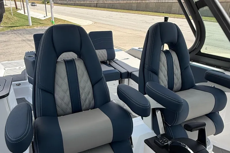 Slide: The Image of Luxury seating on 2026 Monterey 27 SD Elite boat, featuring plush navy and gray upholstery. - 16