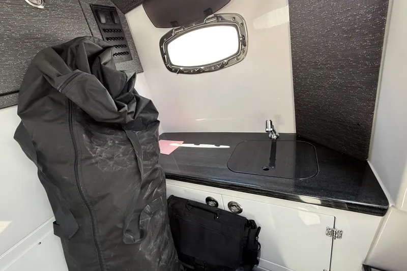 Slide: The Image of Interior of 2026 Monterey 27 SD Elite boat with sink and storage. - 18