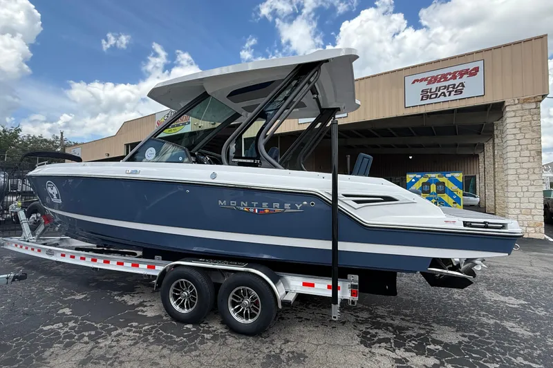 Slide: The Image of 2026 Monterey 27 SD Elite boat on trailer, parked outside a dealership under a cloudy sky. - 3