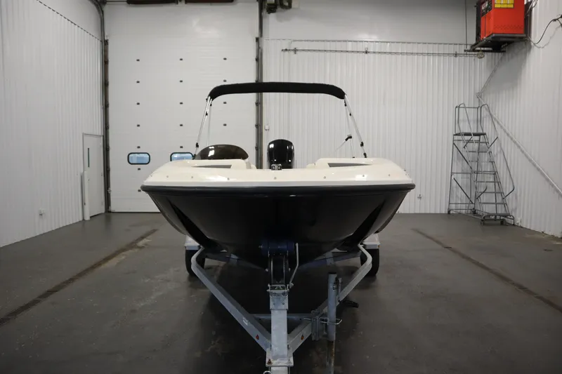 Slide: The Image of 2021 Bayliner 16 Element boat on trailer in indoor storage facility. - 2