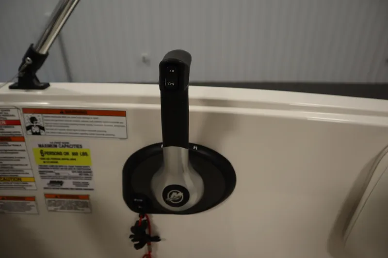 Slide: The Image of Throttle control of 2021 Bayliner 16 Element boat with safety warnings and capacity label. - 21