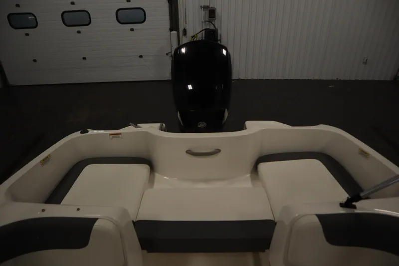 Slide: The Image of 2021 Bayliner 16 Element boat interior with seating and outboard motor in a garage. - 27
