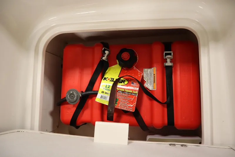 Slide: The Image of Red fuel tank in 2021 Bayliner 16 Element boat storage compartment. - 28