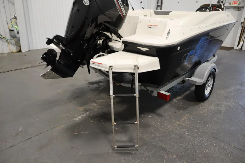 Slide: The Image of 2021 Bayliner 16 Element boat with outboard motor and trailer in a garage. - 30