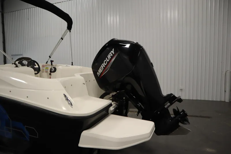 Slide: The Image of 2021 Bayliner 16 Element boat with Mercury outboard motor in a garage setting. - 31