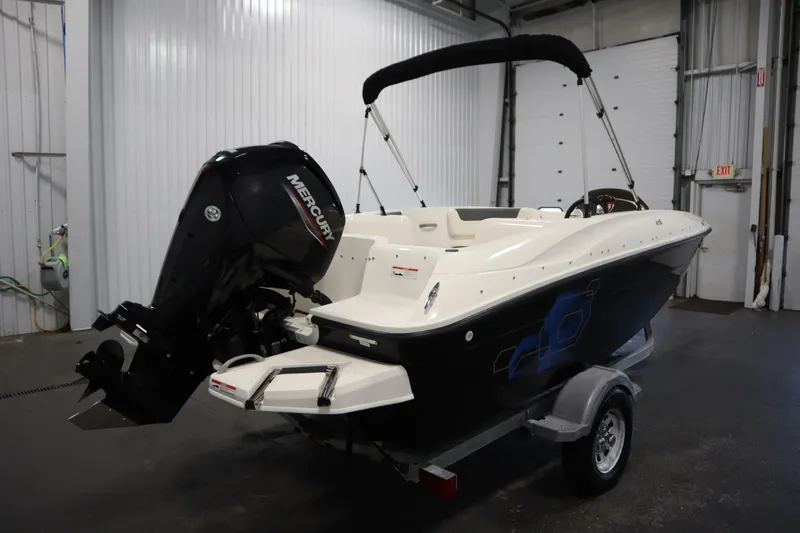 Slide: The Image of 2021 Bayliner 16 Element boat with Mercury outboard motor in a garage setting. - 5